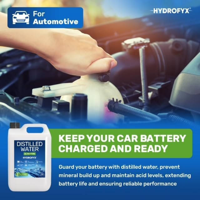 Person topping up a car battery reservoir, demonstrating the use of HYDROFYX distilled water to maintain acid levels and extend battery life.